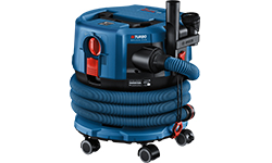 A blue Bosch Professional vacuum cleaner with hose and wheels is ready.