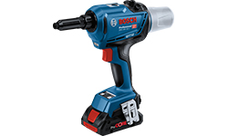 A blue Bosch Professional cordless screwdriver is on a workbench.