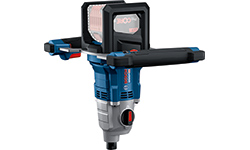 A blue Bosch Professional rotary hammer stands on a white surface.