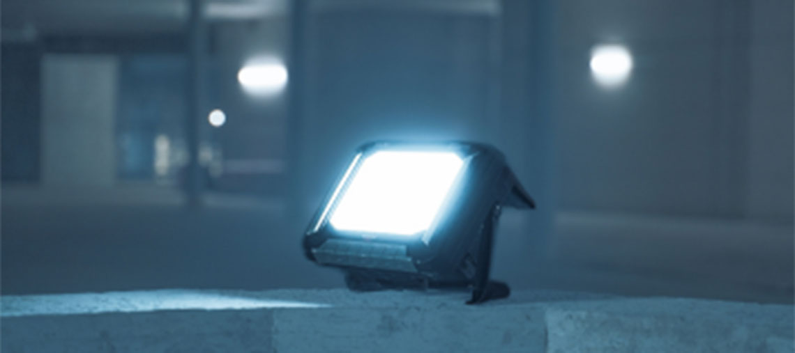 A Bosch Professional construction light illuminates a gray surface.