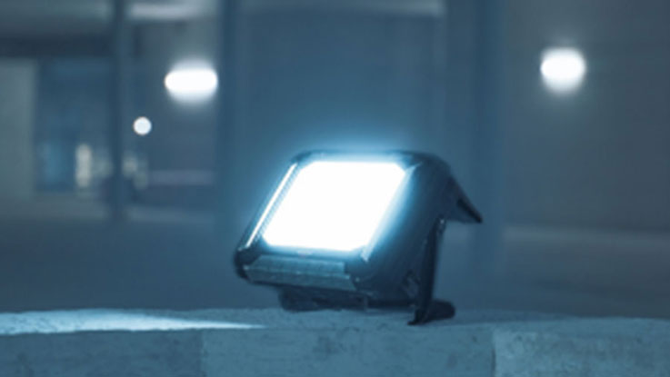 A Bosch Professional LED work light shines brightly on a table.