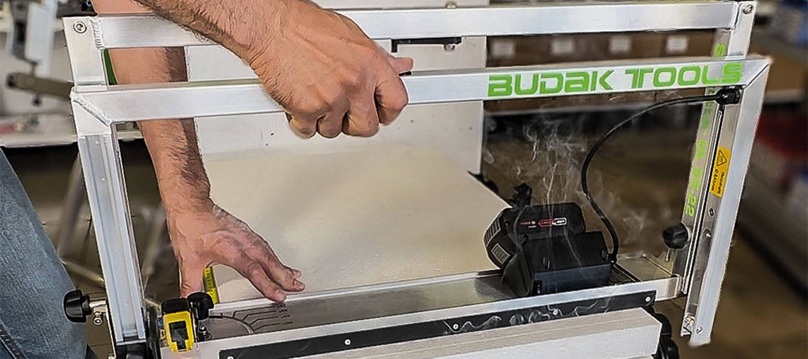 A craftsman uses a Budak Tools machine to work with wood.