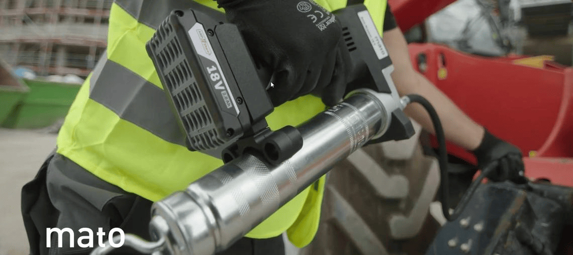 A worker holds a Bosch Professional tool with a battery in hand.