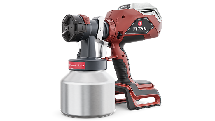 A red Titan spray device stands next to a silver paint container.