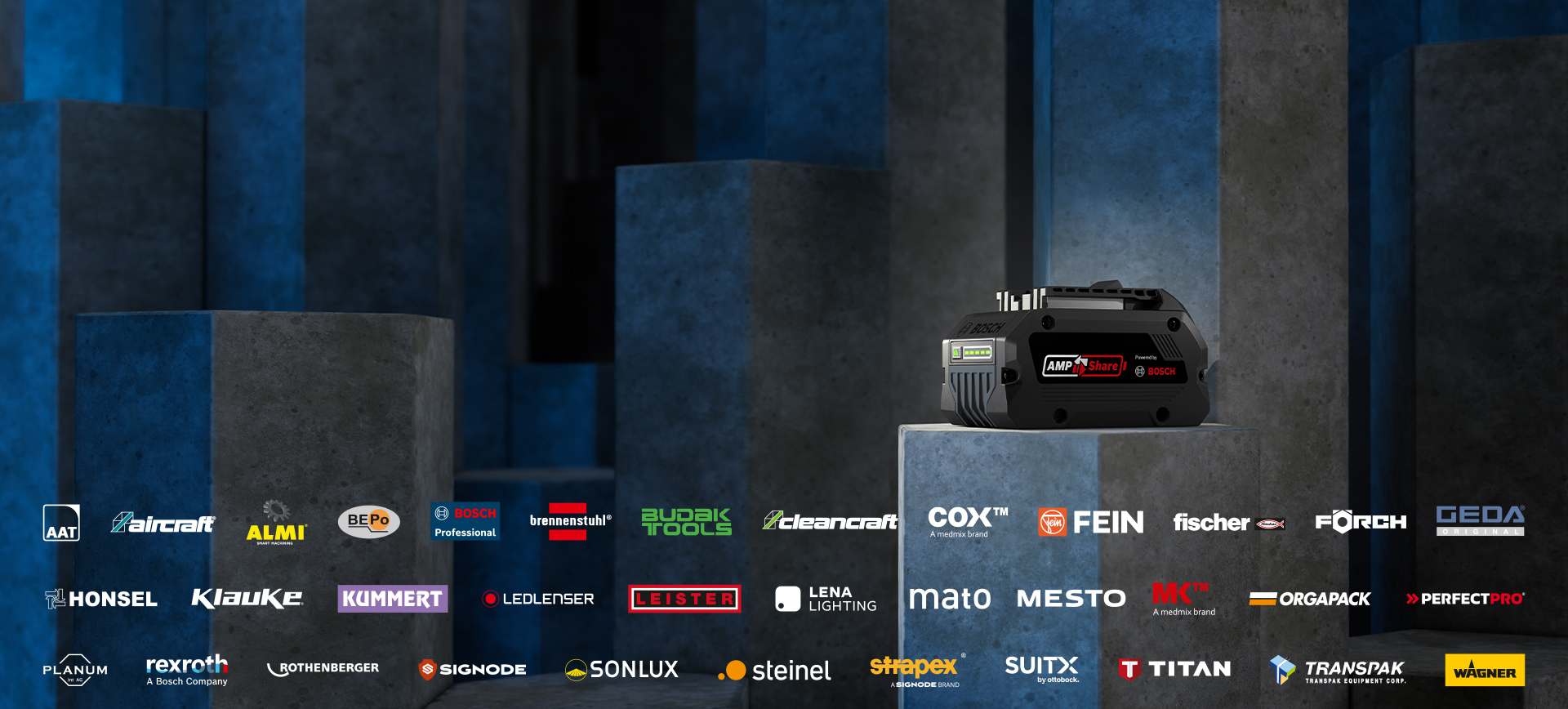 Black Bosch Professional battery on gray base in front of blue wall.