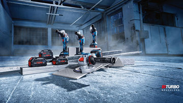 Three Bosch Professional tools are standing on a concrete floor with batteries.