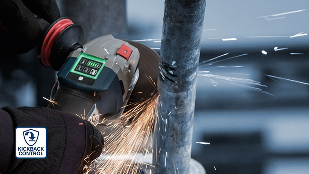 A Bosch Professional grinding machine cuts a metal pipe, sparks fly.