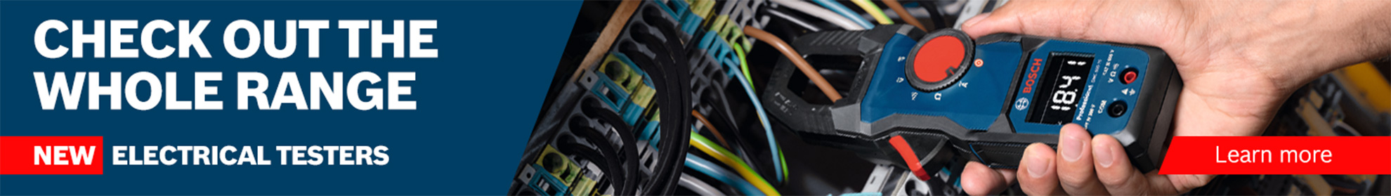 Close-up of a hand holding a blue electrical tester, surrounded by wires.