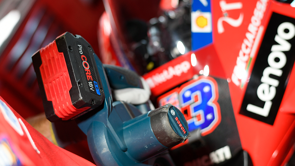 A red Bosch Professional battery with a black handle on a tool.