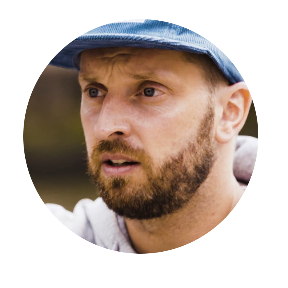 A man with a blue hat is looking intently into the distance.