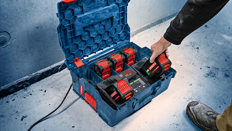 An open Bosch Professional toolbox with batteries and charger.