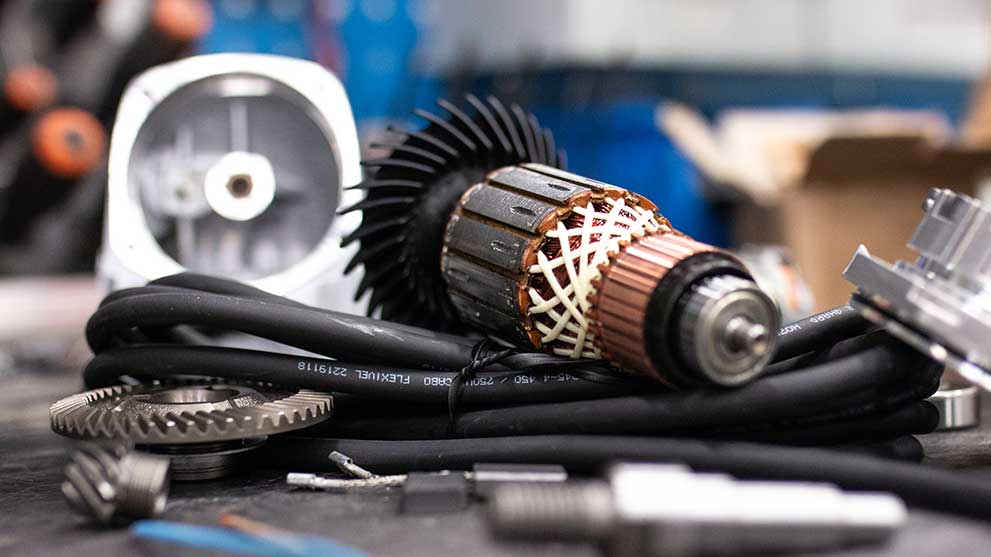 Bosch Professional tool parts are chaotically lying on a workbench.